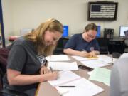 Alison Warlitner, from left, studies with friends Ashley Hopkins and Terri Vanderweide at the Clark College Veterans Resource Center on June 5. Warlitner is a Navy veteran and reservist who says she appreciates how the center supports her and her classmates.