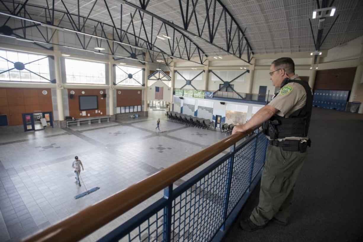 Jason Granneman, school resource officer at Hockinson High School and deputy with the Clark County Sheriff’s Office, keeps an eye on activities in the school from the second floor. In addition to developing initiatives at the high school, Granneman serves as a member a statewide Mass Shooting Task Force formed earlier this year.