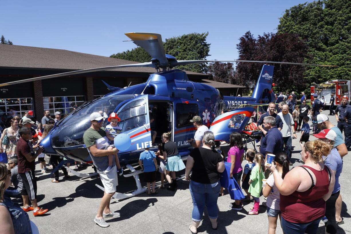 People crowd around the Lifeflight helicopter at the Clark County Fire District 6 open house.