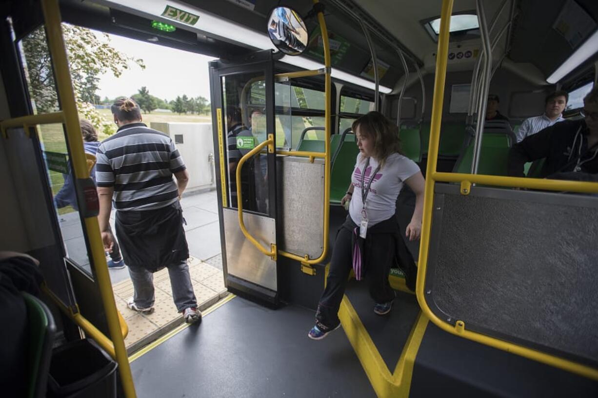 Gateway to Adult Transition Program student Harmony Steffen, center, exits the bus Friday morning after riding to the Marshall Community Center using the Youth Opportunity Pass.