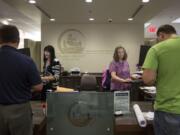 Jodi Creamer, left, and Trina Siebart are the front-line staff at the Clark County Permit Center, which county officials are currently seeking to overhaul.