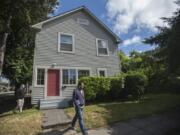 Amanda Cowan/The Columbian Brad Richardson, left, executive director of the Clark County Historical Museum, explores historic downtown Vancouver properties with Alexander Gall of the Clark County Historic Preservation Commission. This 1905 home is known as the Sullinger House; its occupant, the Rev. Spencer S. Sullinger, was district superintendent for the Methodist Church here as well as president of the American Rose Society and curator of Portland’s International Rose Test Garden. But you’d never know any of that if Richardson and the museum weren’t preserving photos, records and stories of the history of downtown Vancouver.