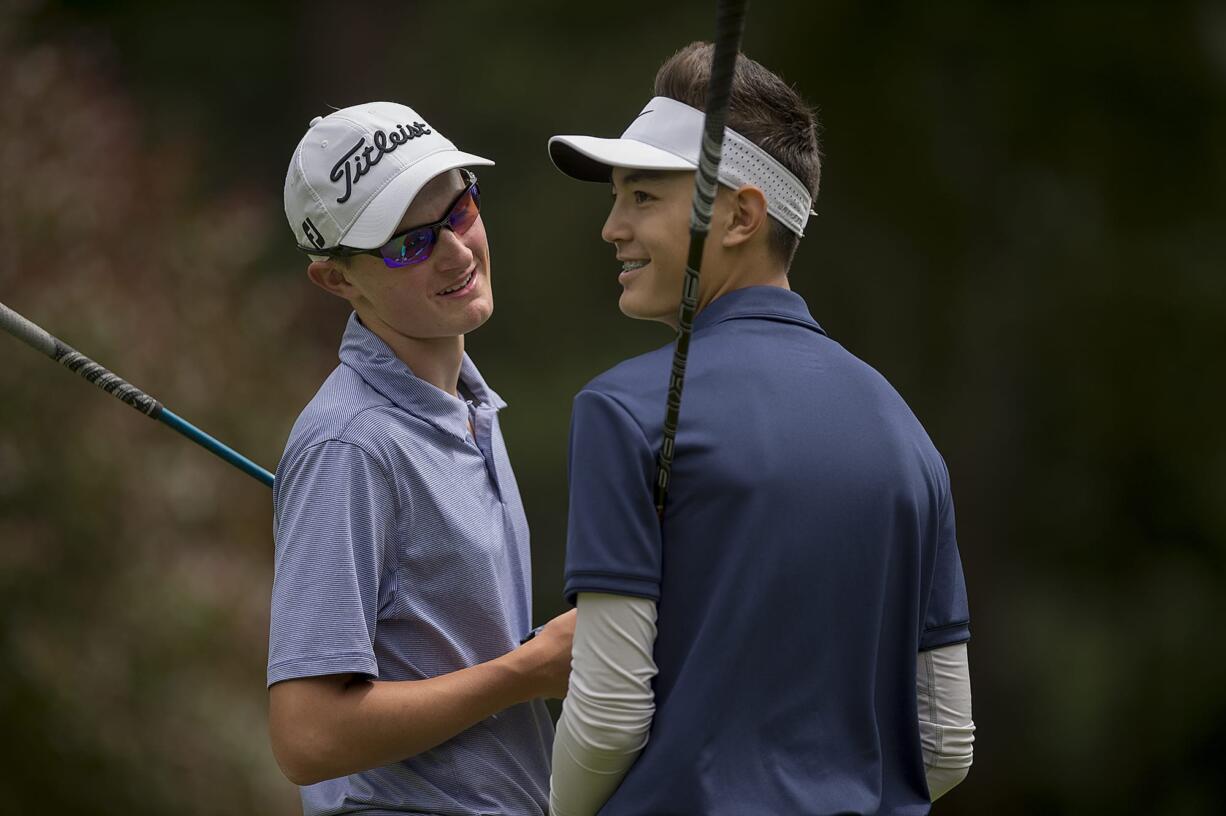 Graham Moody, left, and Cade Bringhurst take a moment to chat before teeing off on the fourth hole during the Royal Oaks Invitational at Royal Oaks Country Club on Friday afternoon, June 8, 2018.