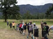 Canyon Creek Middle School students play a game of fire tag at Doetsch Day Use Area in Beacon Rock State Park on Thursday. The game simulates how wildfires grow and spread.