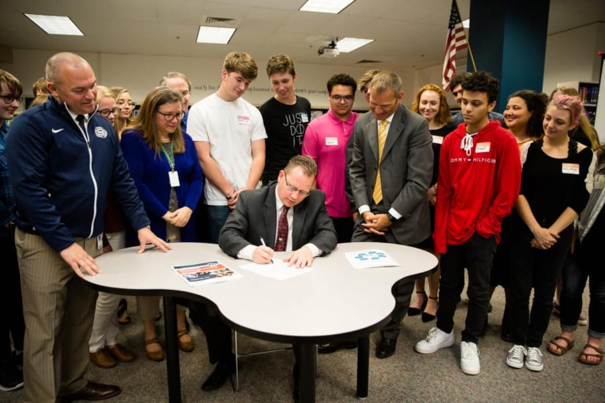 Felida: Washington State Superintendent of Public Instruction Chris Reykdal signs new statewide technology standards during a visit to Skyview High School.