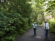 Vancouver residents Alice Perry Linker, left, and Fred Suter discuss what the forest between Moulton Falls and Lucia Falls parks might look like after timber is harvested in the area. The Washington Department of Recreation is planning the Michigan Trotter Timber Sale for January, which includes trees along 2,500 feet of the trail.