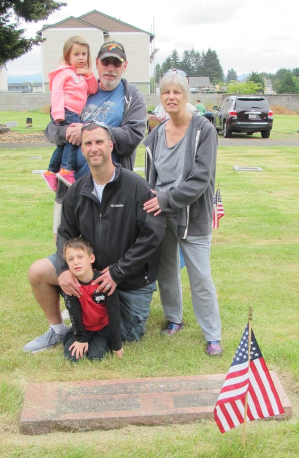 Brush Prairie: Fort Vancouver Daughter of the American Revolution member Cathy Zweig, right, with her family at an event where the organization put flags at the graves of veterans at Brush Prairie Cemetery.