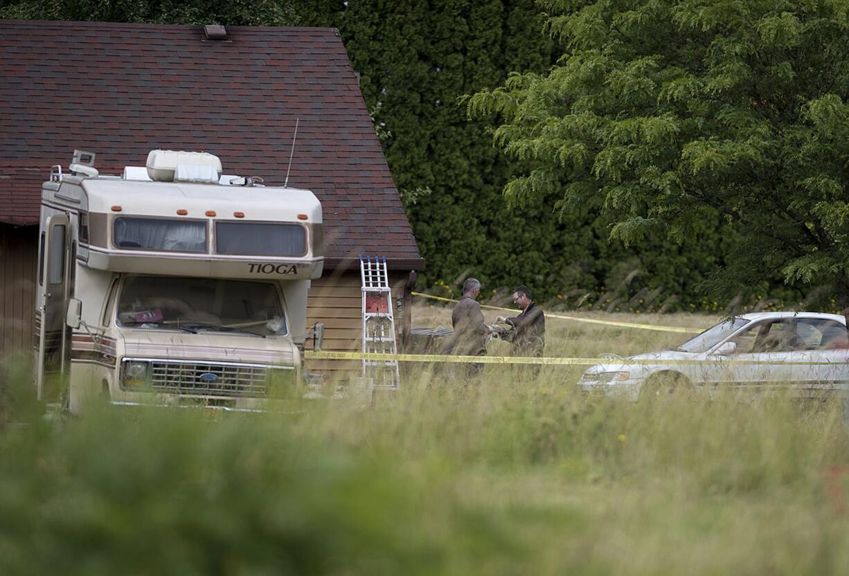 Law enforcement officials work at the scene of an officer-involved shooting at 11518 Northeast 126th Avenue in Brush Prairie on Wednesday afternoon, June 13, 2018.