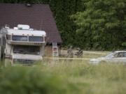 Law enforcement officials work at the scene of an officer-involved shooting at 11518 Northeast 126th Avenue in Brush Prairie on Wednesday afternoon, June 13, 2018.