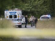 Law enforcement officials work at the scene of an officer-involved shooting at 11518 Northeast 126th Avenue in Brush Prairie on Wednesday afternoon, June 13, 2018.