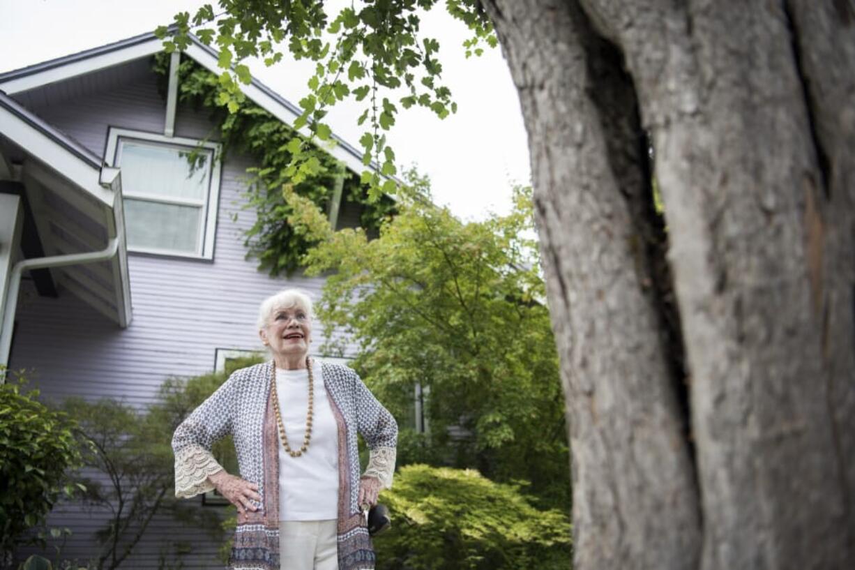 Local historian Pat Jollota admires one of the few remaining scarlet hawthorn trees on Franklin Street in the Hough neighborhood. The trees were planted in 1941 after residents formed a neighborhood group because they were upset the city knocked down older trees while widening Franklin Street. Jollota said things like the two remaining hawthorn trees and neighborhood names are important to preserve so there is a connection to local history.