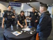 Officer Katie Endresen, Officer Danielle Wass and Sgt. Barb Kipp of the Vancouver Police Department share information about the police force April 28 at the Women In Law Enforcement Career Fair at the state Criminal Justice Training Center in Burien.