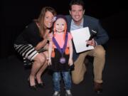 Central Vancouver: Lyla Hopper-Lopez, 4, center, was honored as a Children’s Cancer Association 2018 CCA Hero at an event at the Oregon Museum of Science and Industry hosted by Regina Ellis, association founder and chief joy officer, left, and Drew Carney of KGW-TV.