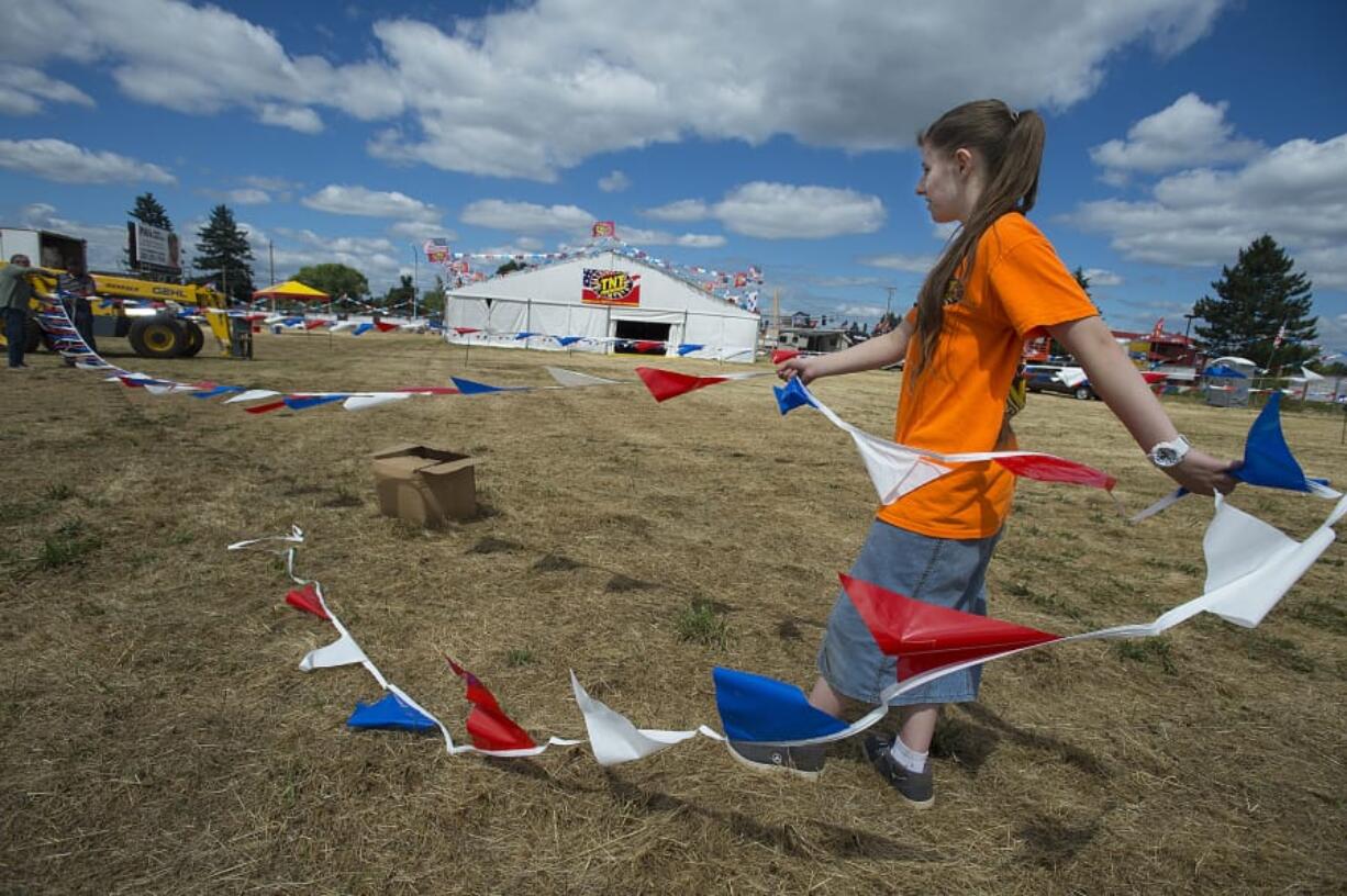 Abby Jones, member of United Pentecostal Church in Vancouver, works with fellow church members as they prepare the church’s fireworks stand for customers in Orchards on Tuesday morning. The stand, which is located at the intersection of Northeast 117th Avenue and Northeast 71st Street, has been selling fireworks as a fundraiser for more than 30 years. They open for sales Thursday from noon to 11 p.m. and then daily through July 4 from 9 a.m. to 11 p.m.