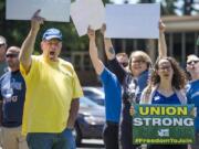 Union members and supporters rally against the U.S. Supreme Court’s decision in Janus v. AFSCME at the corner of Fort Vancouver Way and East Mill Plain Boulevard on Wednesday afternoon.