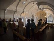 Employees from Providence Health & Services pause to take in the view from the chapel balcony at Providence Academy during a Wednesday tour of the historic building in Vancouver.