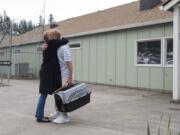 Craig Bigler embraces his mother, Lezlie Deuchrass, after being released from Larch Corrections Center near Yacolt on Thursday morning. Bigler participated in the Larch Pet Training Camp for cats for 18 months during his time at the corrections center.