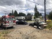 Officials work around the aftermath of a T-bone crash that sent the driver in the tan sedan to the hospital with critical injuries Monday afternoon. Firefighters had to cut the injured driver from the car.