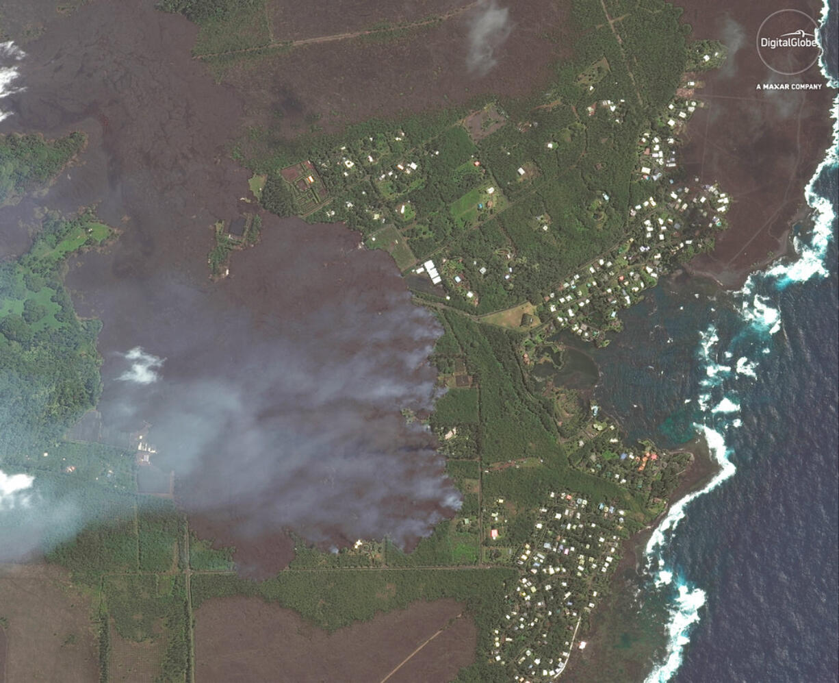 This satellite image provided by Digital Globe captured June 3, 2018, shows advancing lava flows on Hawaii as they approach Kapoho Bay and the Vacationland residential neighborhood.  Lava from the erupting Hawaii volcano has destroyed more than 100 homes in a rural Big Island district.  Hawaii County spokeswoman Janet Snyder says as of Monday, June 4, 2018, lava burned down 117 homes. Snyder says that’s up from Friday’s count of 87.