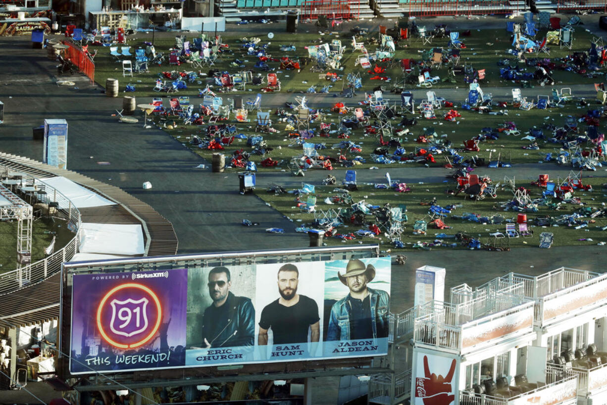 FILE - In this Oct. 3, 2017 file photo, personal belongings and debris litters the Route 91 Harvest festival grounds across the street from the Mandalay Bay resort and casino in Las Vegas. Police are scheduled to release more public records under court order from the investigation of the shooting on the Las Vegas Strip last October that was the deadliest incident of its kind in the nation's modern history.