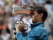 Spain's Rafael Nadal holds the trophy as he celebrates winning the men's final match of the French Open tennis tournament against Austria's Dominic Thiem in three sets 6-4, 6-3, 6-2, at the Roland Garros stadium in Paris, France, Sunday, June 10, 2018.