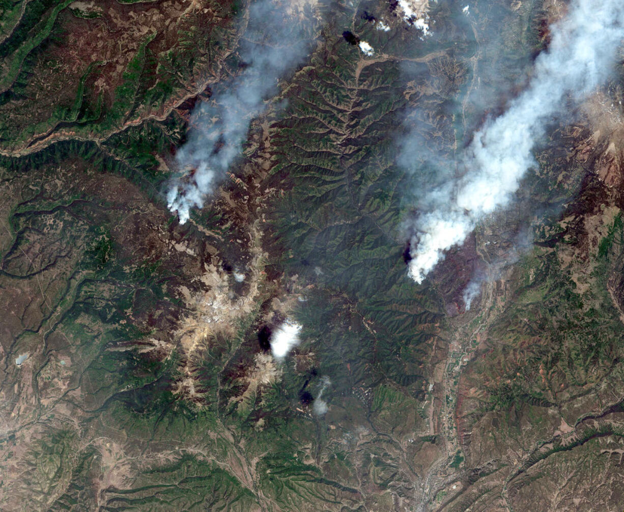 This June 9, 2018, satellite image provide by DigitalGlobe shows the 416 Fire, right, and the Burro Fire, left, northwest of Durango, Colo.