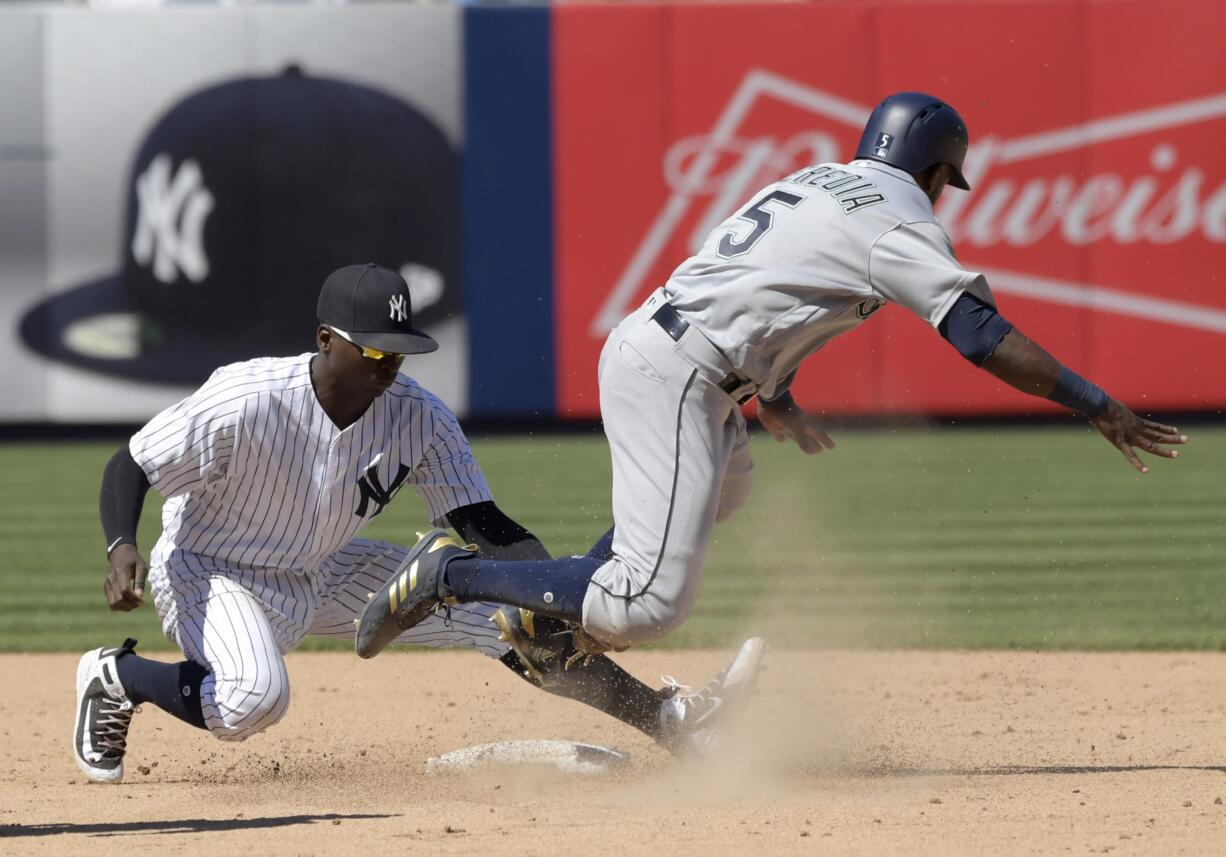 Seattle Mariners pinch runner Guillermo Heredia (5) is caught stealing as he is tagged out by New York Yankees shortstop Didi Gregorius (18) during the eighth inning of a baseball game Thursday, June 21, 2018, at Yankee Stadium in New York.