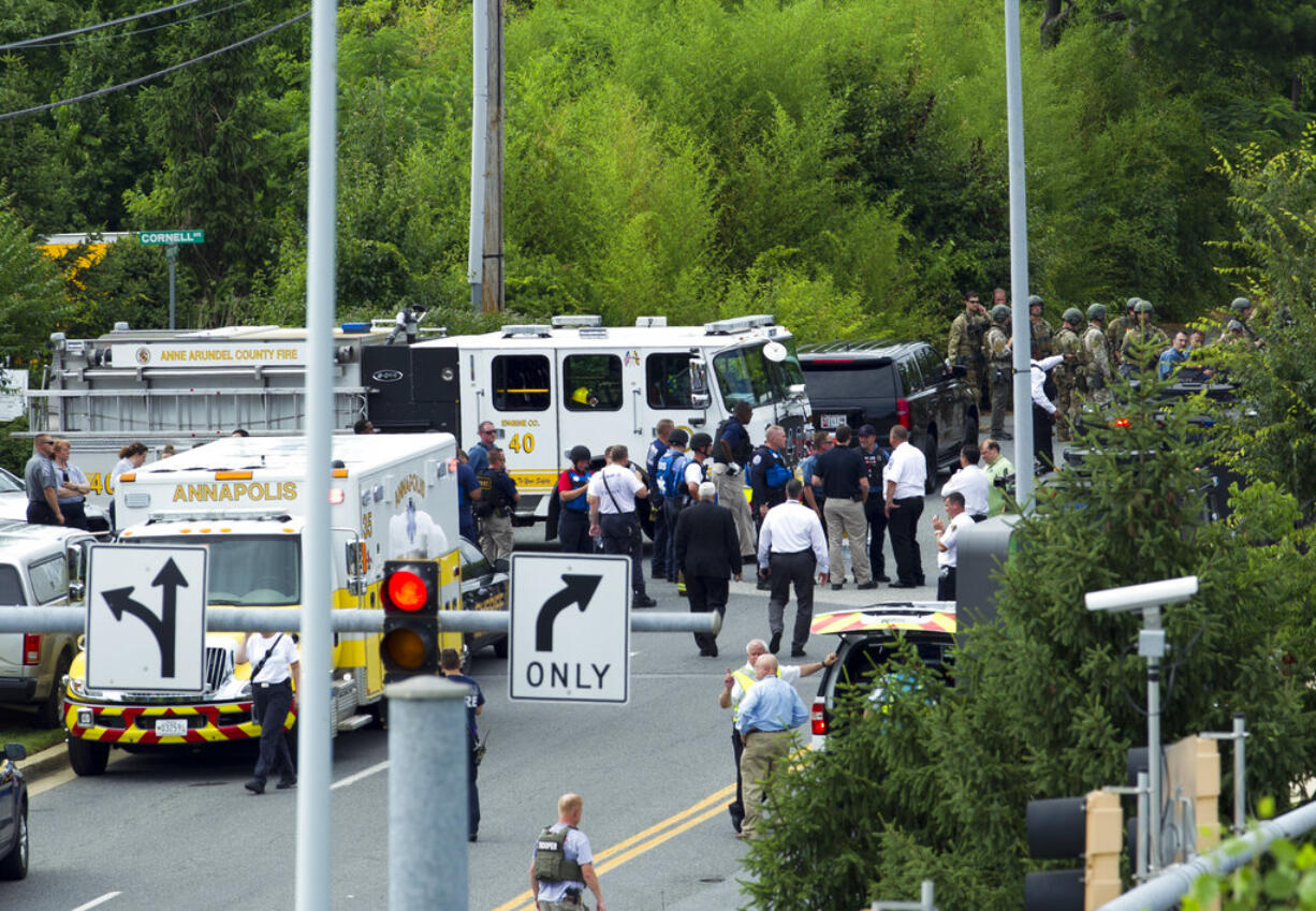 Authorities stage at the building entrance after multiple people were shot at The Capital Gazette newspaper in Annapolis, Md., Thursday, June 28, 2018.