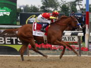 Justify (1), with jockey Mike Smith up, crosses the finish line to win the 150th running of the Belmont Stakes horse race, Saturday, June 9, 2018, in Elmont, N.Y.