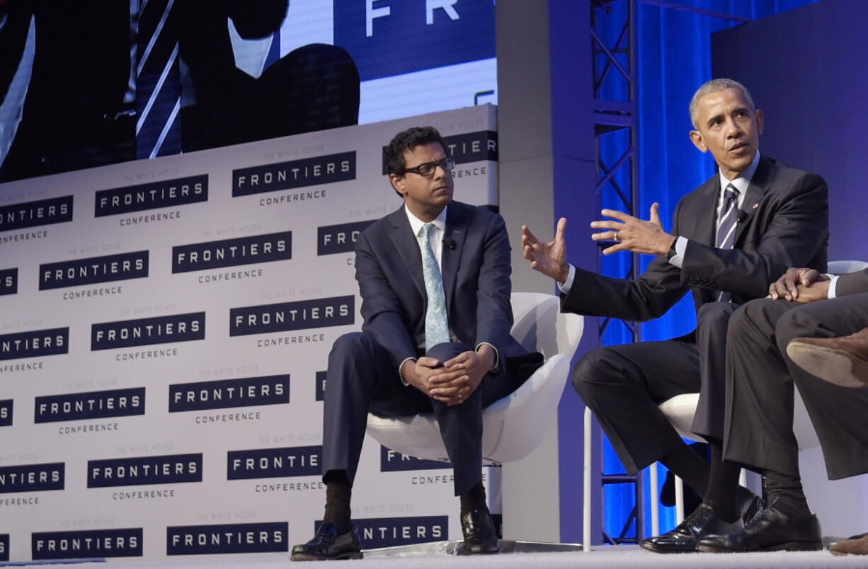 Dr. Atul Gawande, left, listens as President Barack Obama speaks during a panel discussion at the White House Frontiers Conference at Carnegie Mellon University in Pittsburgh in 2016. Amazon, JPMorgan Chase and Berkshire Hathaway are turning to well-known author and Harvard professor Gawande to transform the health care they give their employees. The three corporate titans said Wednesday, June 20, 2018, that Gawande will lead an independent company that focuses on a mission they announced earlier this year: figure out ways to provide high-quality, affordable care.