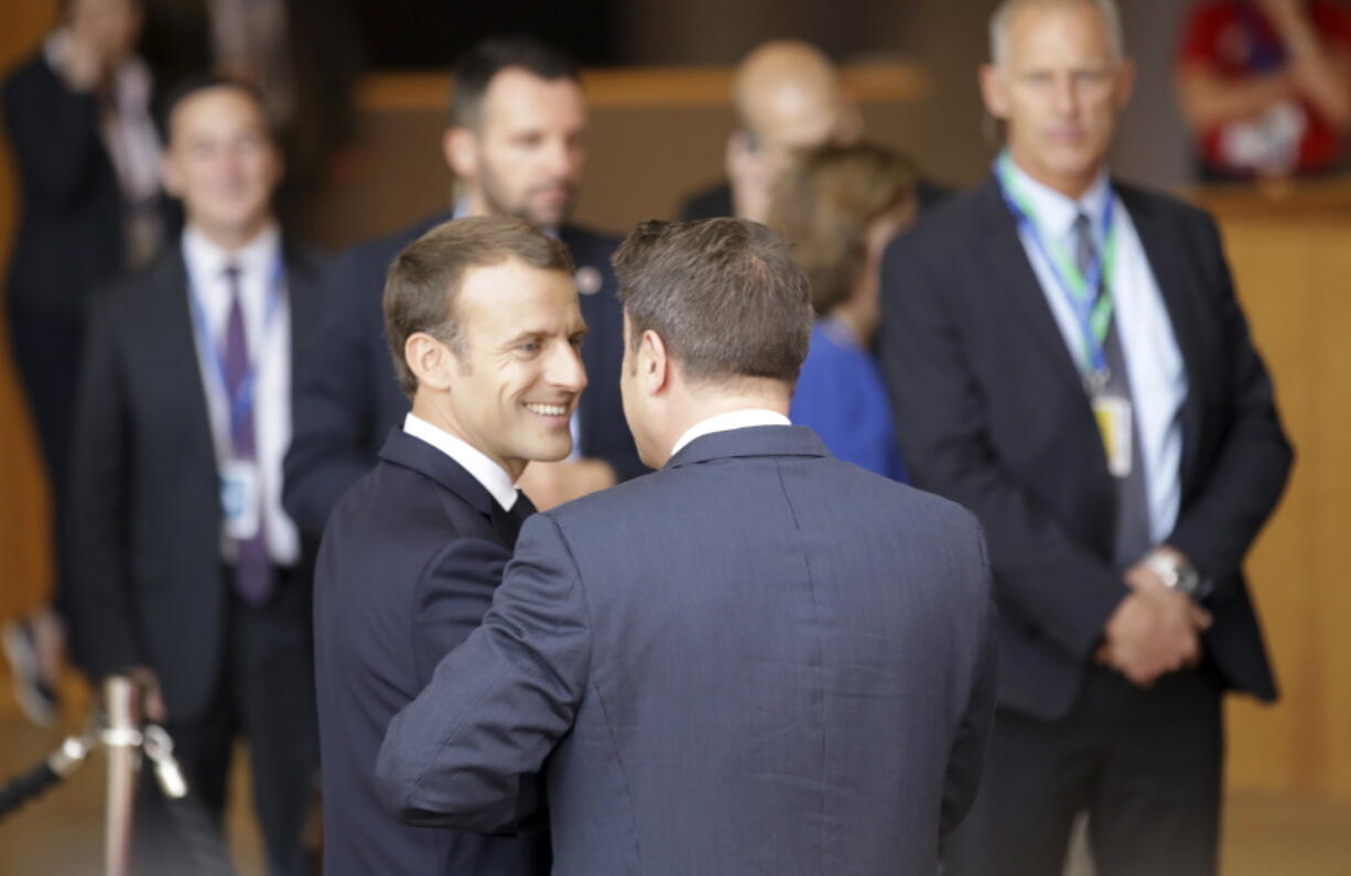 French President Emmanuel Macron, center left, speaks with Luxembourg’s Prime Minister Xavier Bettel, center right, as he arrives for an EU summit in Brussels, on Friday. European Union leaders were set to assess the state of stalled Brexit negotiations on Friday, after British Prime Minister Theresa May warned them that failure to strike a good divorce deal could endanger European security.