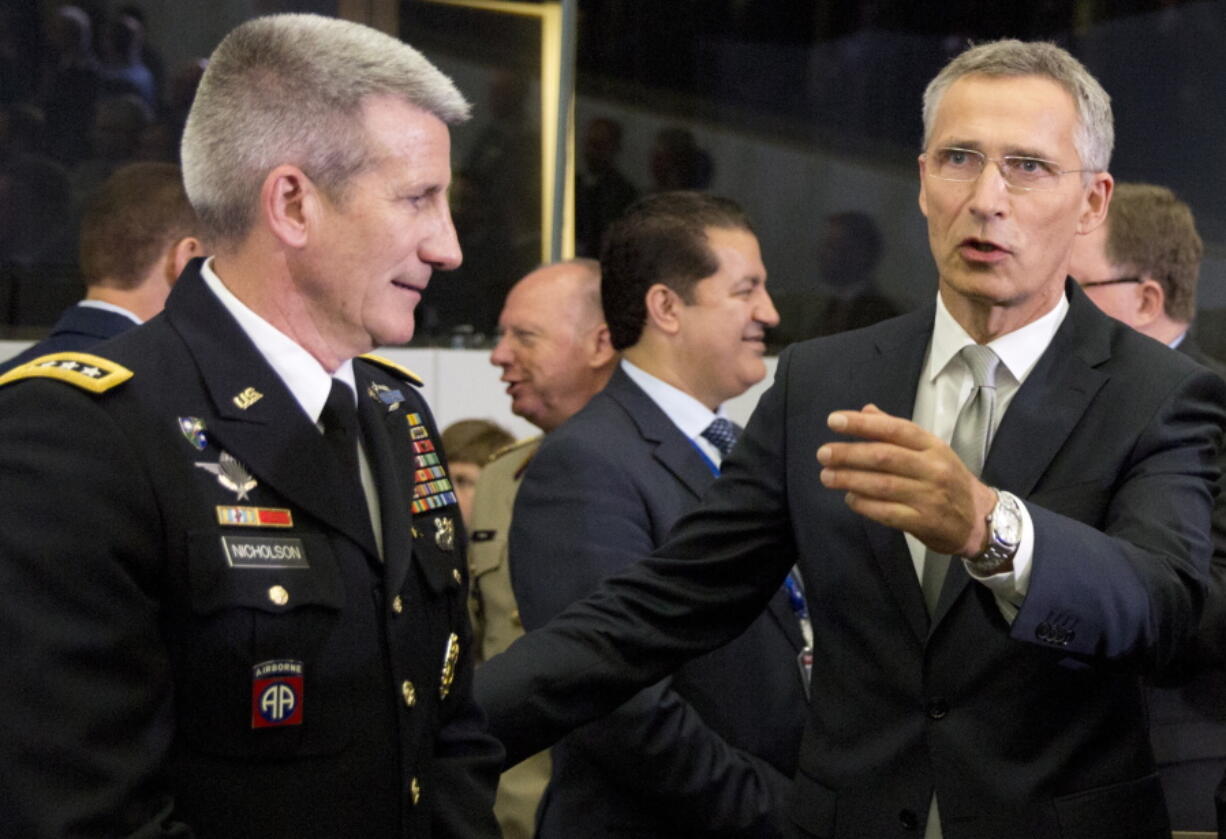 NATO Secretary General Jens Stoltenberg, right, speaks with the top commander of U.S. forces in Afghanistan General John Nicholson during a round table meeting of the North Atlantic Council with Resolute Support Operational Partner Nations at NATO headquarters in Brussels on Friday.