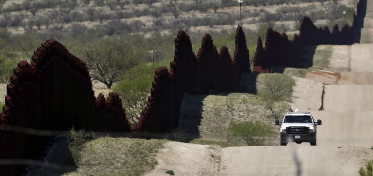 A Customs and Border Patrol agent patrols the international border near Nogales, Ariz. The U.S. Border Patrol says an agent has been wounded in a shooting in southern Arizona near the U.S.-Mexico border.