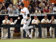 Oregon State's Trevor Larnach (11) celebrates his two-run home run against Arkansas during the ninth inning in Game 2 of the NCAA College World Series baseball finals in Omaha, Neb., Wednesday, June 27, 2018.