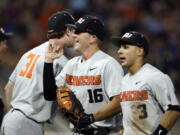 Oregon State first baseman Zak Taylor (16) smiles after a double play against Mississippi State ended the sixth inning of an NCAA College World Series baseball elimination game in Omaha, Neb., Saturday, June 23, 2018.