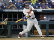 Oregon State designated hitter Kyle Nobach (28) hits a three-run home run in the seventh inning of an NCAA College World Series baseball elimination game against Washington in Omaha, Neb., Monday, June 18, 2018. Oregon State won 14-5.