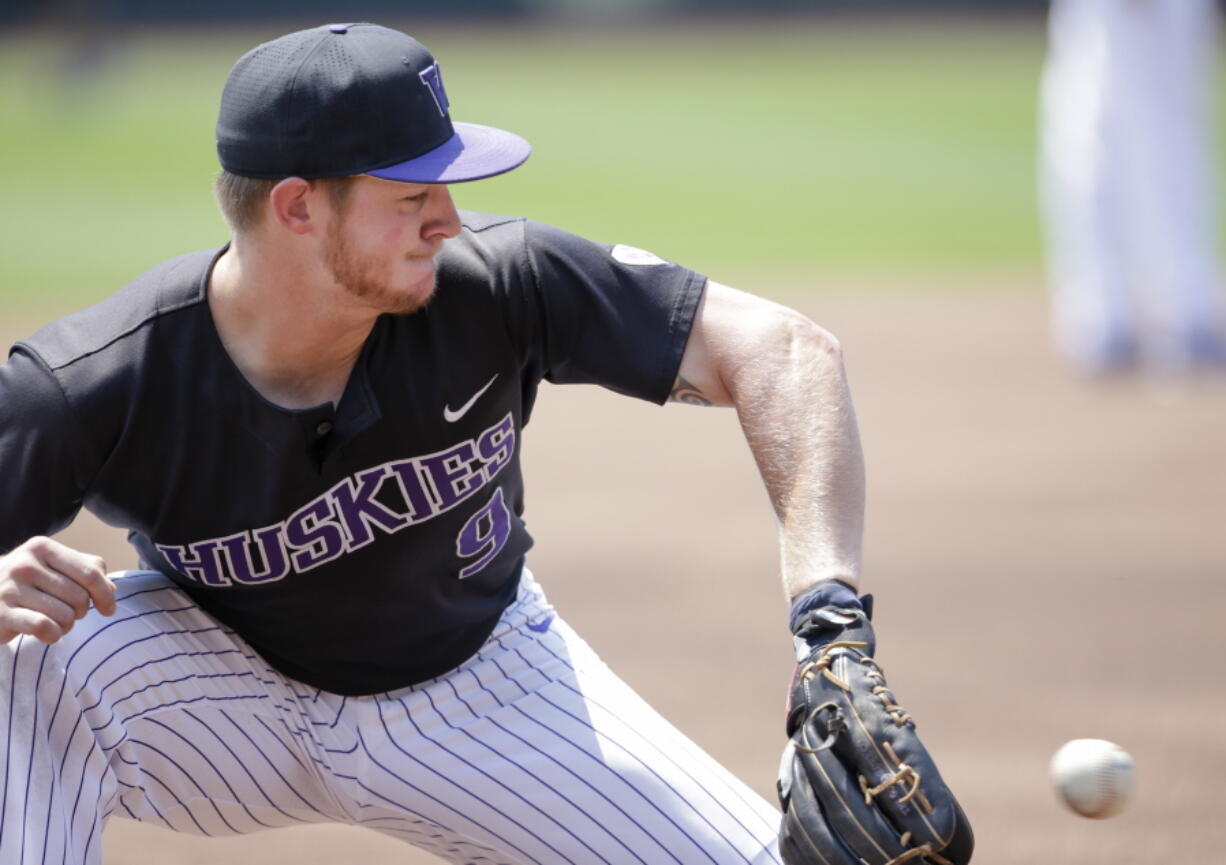 Washington third baseman Willie MacIver (9) fields a ground ball during practice at TD Ameritrade Park in Omaha, Neb., Friday, June 15, 2018. Washington plays Mississippi State on Saturday in the NCAA College World Series baseball tournament..