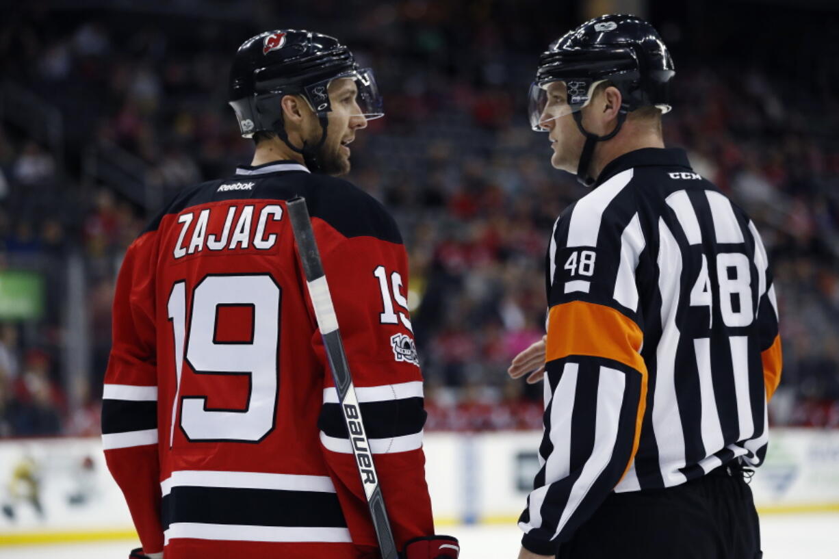 NHL referee Garrett Rank, talking with New Jersey Devils’ Travis Zajac, was co-medallist at his U.S. Open golf qualifying site in Georgia and will play his first U.S. Open this week. Rank is a three-time Canadian Mid-Amateur Champion and represented Canada at the 2015 Pan-Am Games.