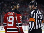 NHL referee Garrett Rank, talking with New Jersey Devils’ Travis Zajac, was co-medallist at his U.S. Open golf qualifying site in Georgia and will play his first U.S. Open this week. Rank is a three-time Canadian Mid-Amateur Champion and represented Canada at the 2015 Pan-Am Games.