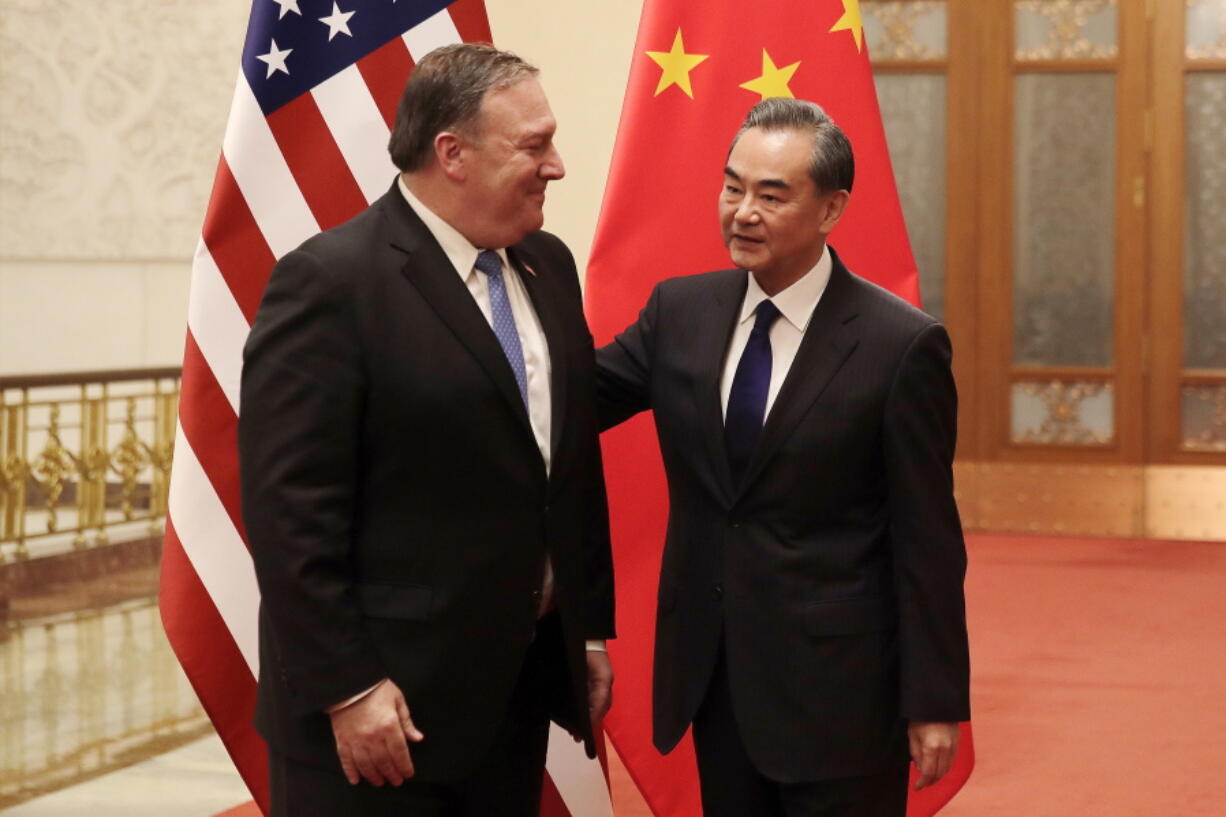 U.S. Secretary of State Mike Pompeo, left, chats with Chinese Foreign Minister Wang Yi before their meeting at the Great Hall of the People in Beijing on Thursday.