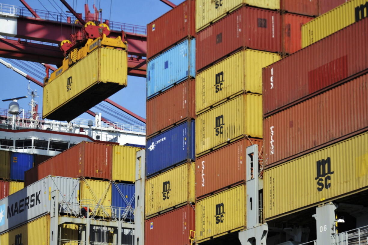 A container is loaded onto a cargo ship at a port in Qingdao, China, in April. China accused the U.S. on Thursday of using pressure tactics and blackmail in threatening to impose tariffs on some Chinese imports.