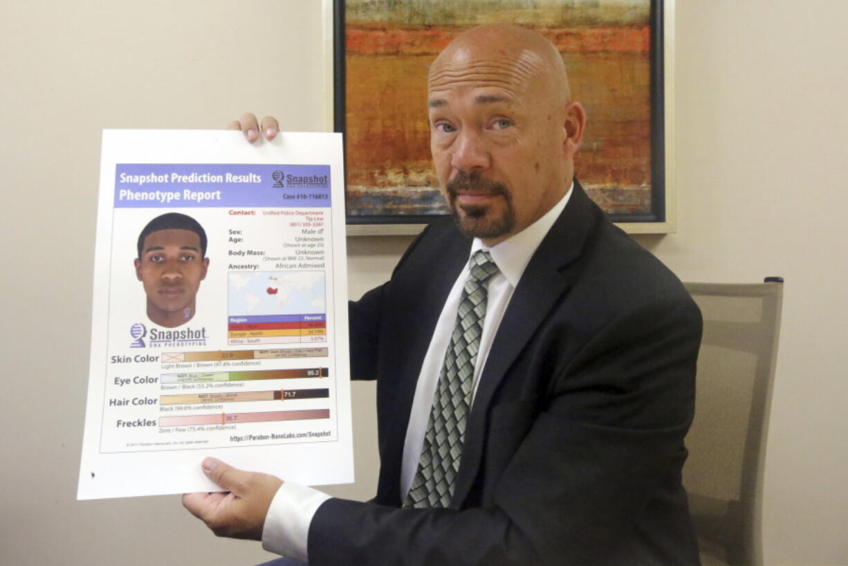 Private investigator Jason Jensen holds a phenotype report at his office Friday in Salt Lake City.