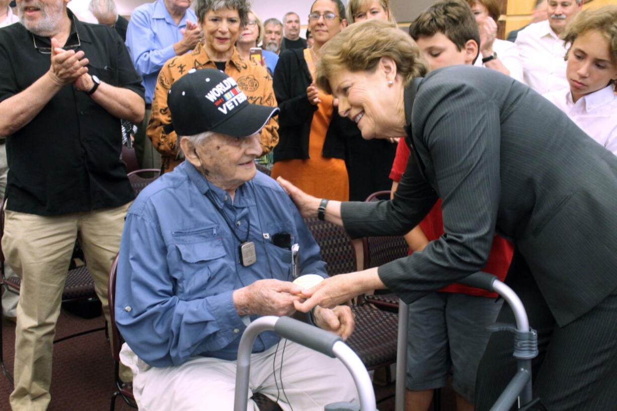 Retired Army Capt. Martin Gelb is presented with the Congressional Gold Medal by U.S. Sen. Jeanne Shaheen, D-N.H., on Monday in Derry, New Hampshire. Gelb, 98, was honored for his World War II service with the Office of Strategic Services, the precursor to the Central Intelligence Agency.