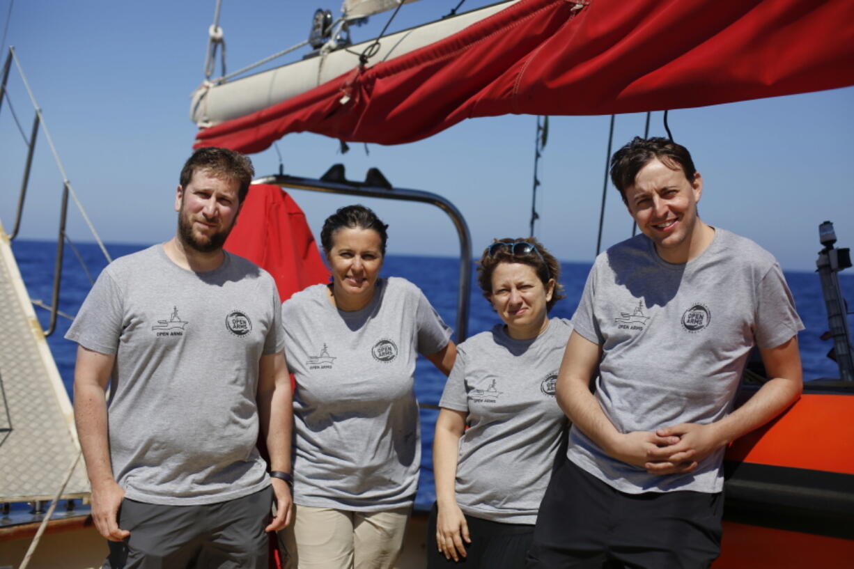 European Parliament members, from left to right, Miguel Urban of Spain, Ana Miranda of Spain, Eleonora Forenza of Italy and Javi Lopez of Spain pose for a picture aboard the Astral as it sails to International waters for an observation mission with the Spanish rescue group Proactiva Open Arms on Thursday. The lawmakers hope to share their accounts at the next European plenary session on July 2-5 in Strasbourg.