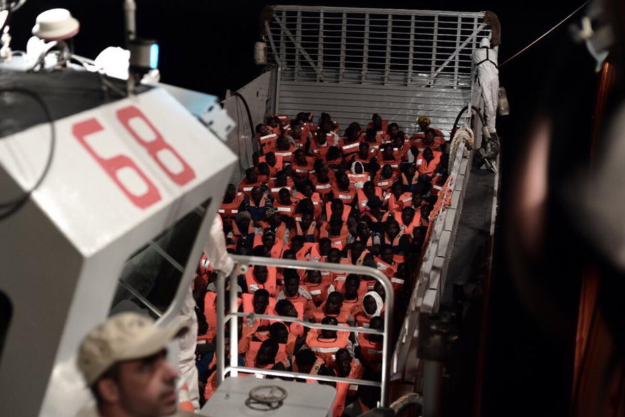 CORRECTS NAME OF BOAT This undated photo released by by French NGO “SOS Mediterranee” on Monday June 11, 2018 and posted on it’s Twitter account, shows migrants about to board the SOS Mediterranee’s Aquarius ship and MSF (Doctors Without Borders) NGOs, in the Mediterranean Sea. Italy and Malta dug in for a second day and refused to let the rescue ship Aquarius with 629 people aboard dock in their ports, leaving the migrants at sea as a diplomatic standoff escalated under Italy’s new anti-immigrant government.