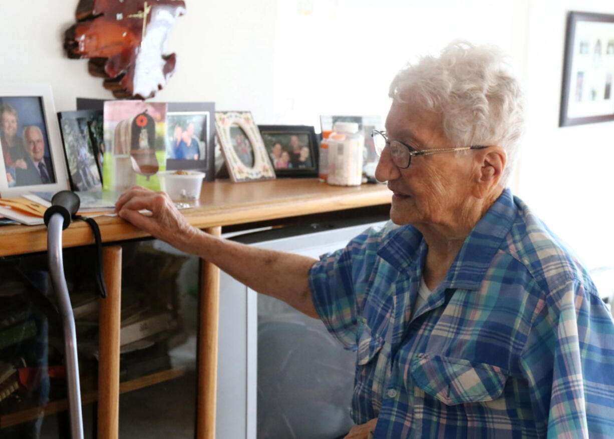 In this Thursday May 31, 2018 photo, Pauline Phillips recalls family memories at her home in Roseburg, Ore. Pauline Phillips leads a busy life. She still drives, does water aerobics every morning at the YMCA, leads Rosary at the Catholic Church and serves dinner at the Elks lodge, defying the fact that she is 98 years old. She was born on April 21, 1920 and has outlived two husbands.