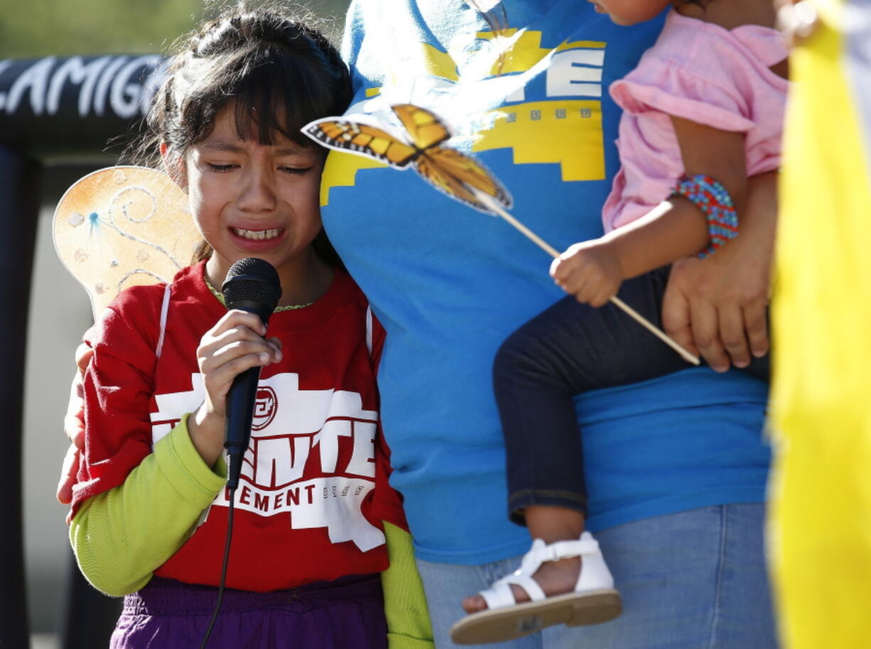 Akemi Vargas, 8, cries as she talks about being separated from her father during an immigration family separation protest in front of the Sandra Day O’Connor U.S. District Court building in Phoenix. Child welfare agencies across America make wrenching decisions every day to separate children from their parents. But those agencies have ways of minimizing the trauma that aren’t being employed by the Trump administration at the Mexican border. (AP Photo/Ross D.