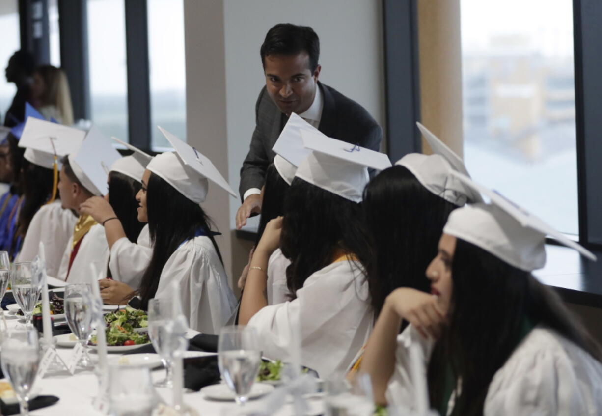 Rep. Carlos Curbelo, R-Fla., greets graduates Tuesday while attending the 34th Annual Farmworker Student Recognition Ceremony in Homestead, Fla. Seventy percent of Curbelo’s constituents are Hispanic, and nearly half are foreign born.