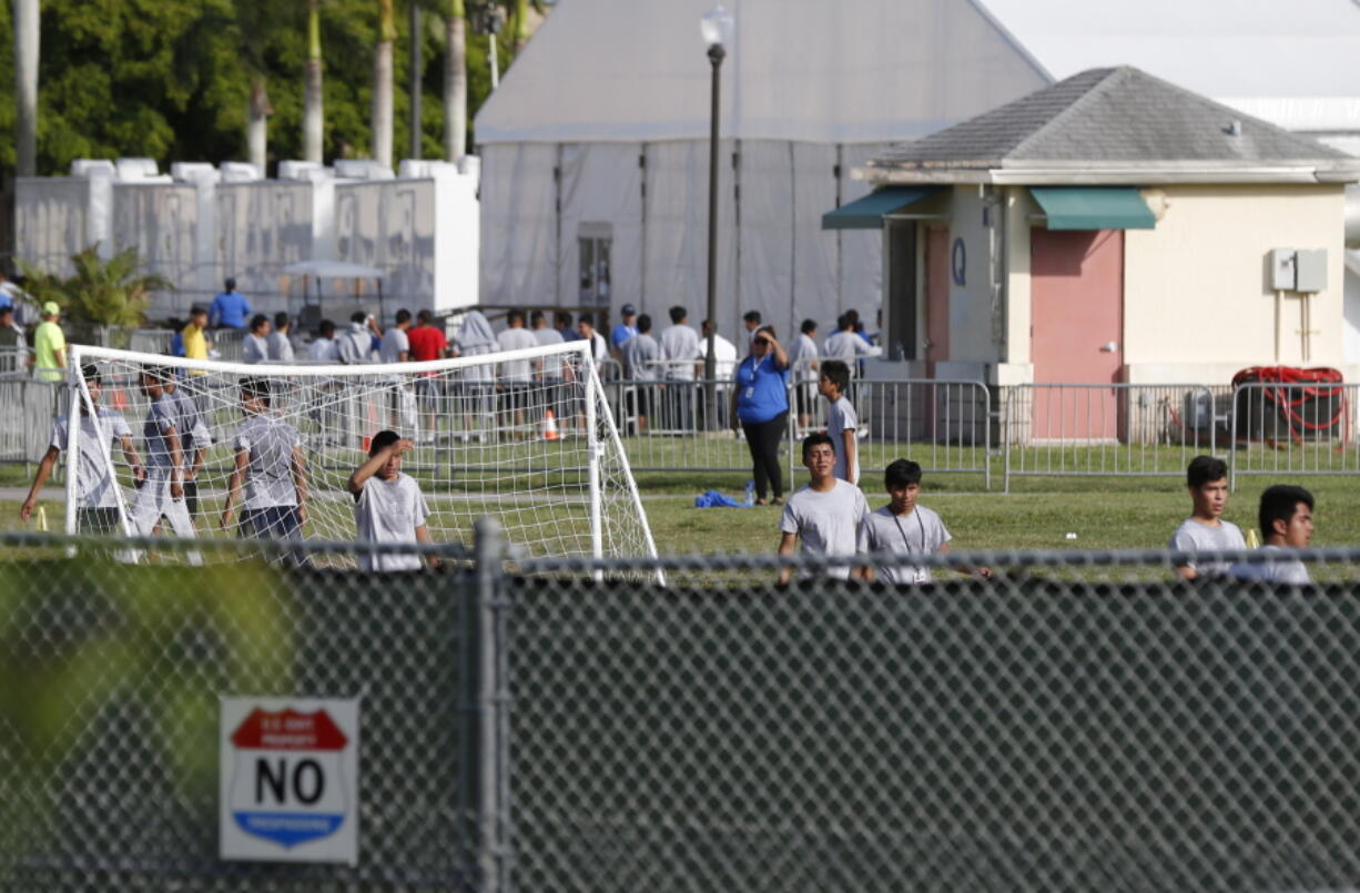 Immigrant children play outside a former Job Corps site that now houses them Monday in Homestead, Fla. It is not known if the children crossed the border as unaccompanied minors or were separated from family members.