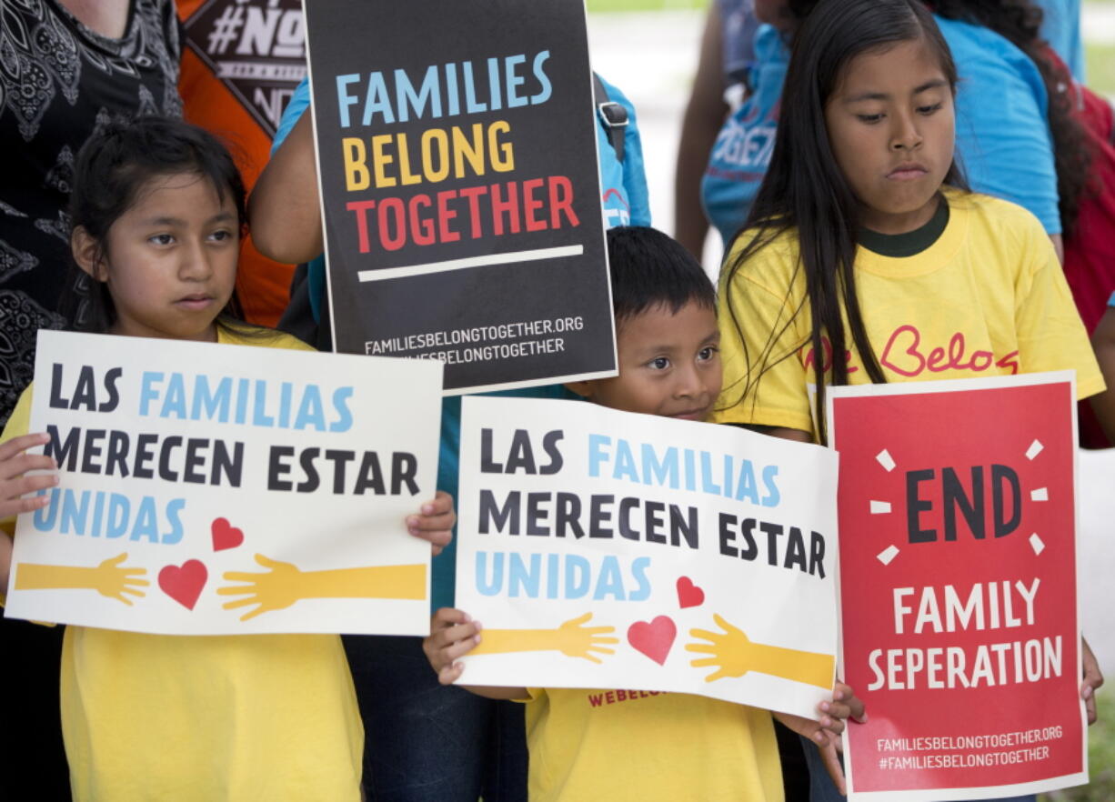 Children hold signs during a demonstration in front of the Immigration and Customs Enforcement offices June 1 in Miramar, Fla.